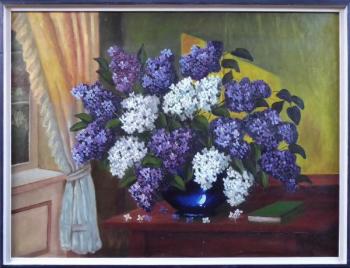 Lilacs in a blue vase on the table by the window Lilacs in a blue vase on the table by the window